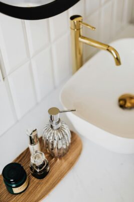 bathroom vanity with gold fixtures