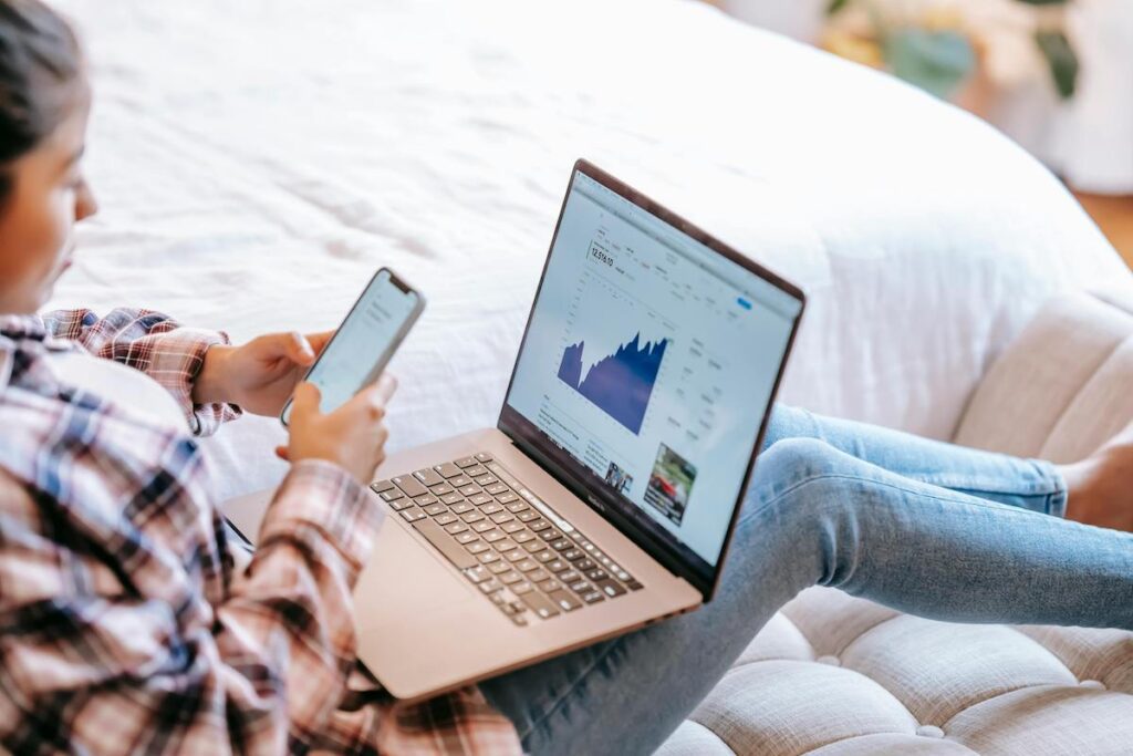 woman on laptop and phone