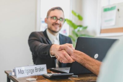 mortgage broker shaking hands with client