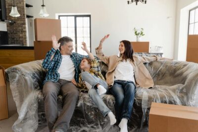 family-high-five-on-couch-in-new-home