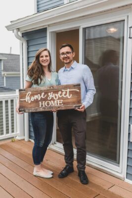 couple with home sweet home sign