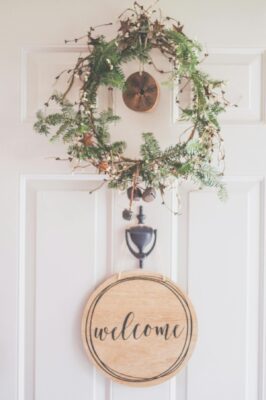 welcome sign and wreath on front door